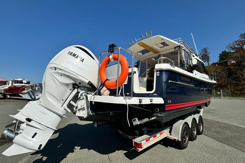  Yacht Photos Pics 2017 Cutwater C-302 Sport Coupe on trailer with Yamaha outboard motor, blue sky background.