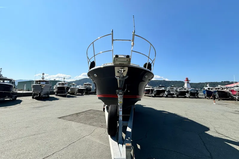  Yacht Photos Pics 2017 Cutwater C-302 Sport Coupe on trailer in marina under clear blue sky.