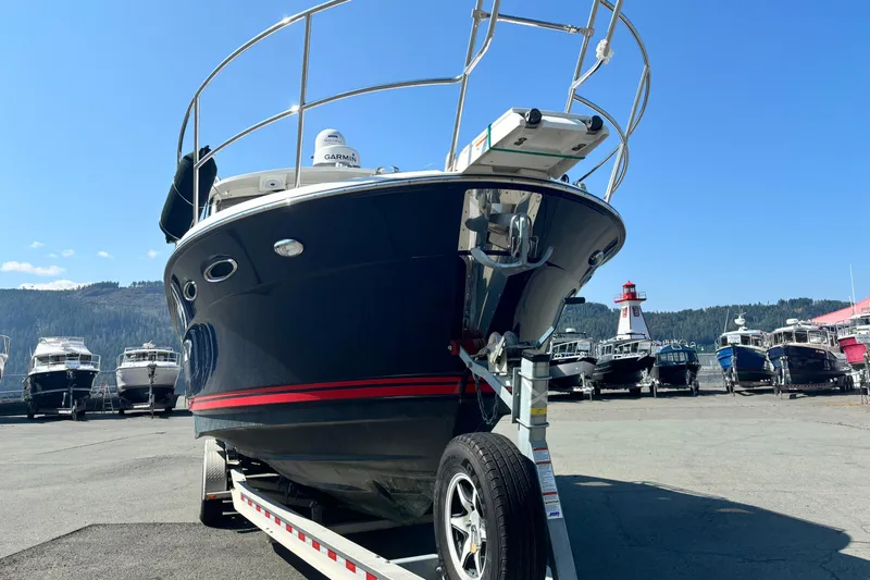  Yacht Photos Pics 2017 Cutwater C-302 Sport Coupe boat on trailer, marina background, clear sky.