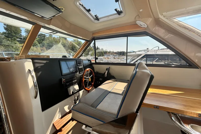  Yacht Photos Pics Interior of 2017 Cutwater C-302 Sport Coupe, featuring helm with steering wheel and navigation screens.