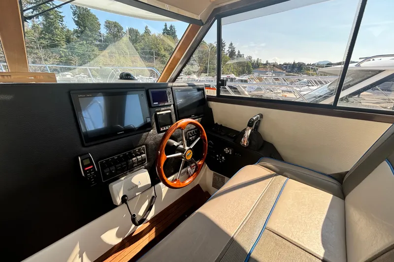  Yacht Photos Pics Interior of 2017 Cutwater C-302 Sport Coupe boat with steering wheel and navigation equipment.