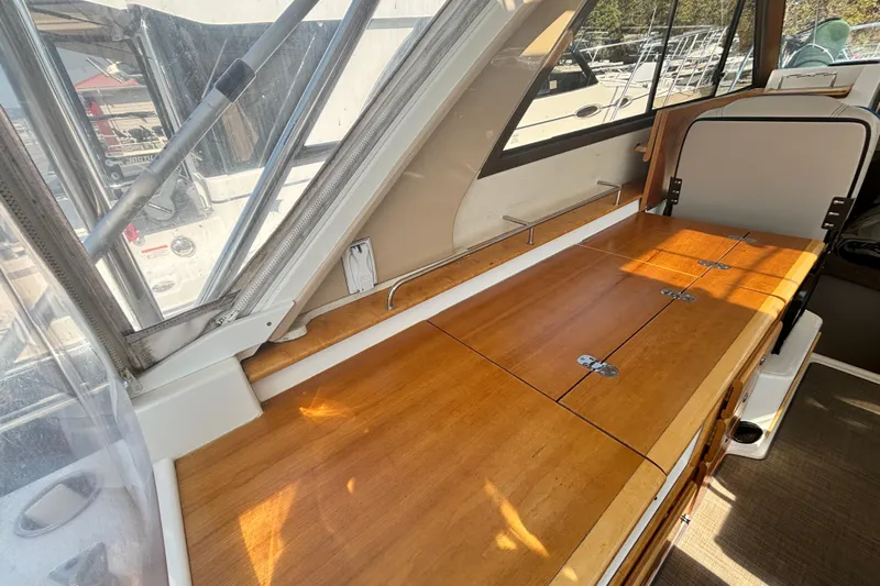  Yacht Photos Pics 2017 Cutwater C-302 Sport Coupe interior with wooden table and window view.