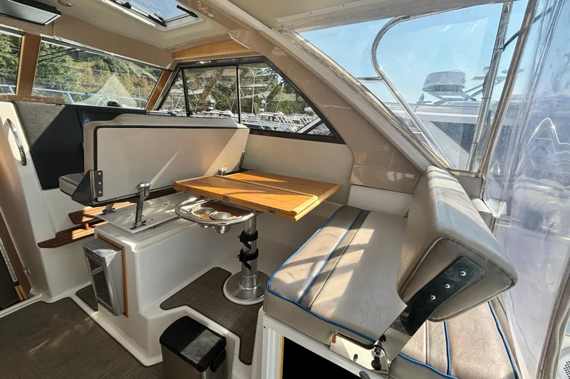  Yacht Photos Pics 2017 Cutwater C-302 Sport Coupe interior with seating and wooden table.