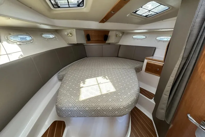  Yacht Photos Pics 2017 Cutwater C-302 Sport Coupe cabin interior with bed and portholes.
