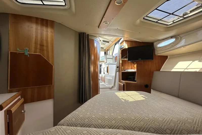  Yacht Photos Pics Interior of 2017 Cutwater C-302 Sport Coupe, featuring cozy cabin with bed and TV.