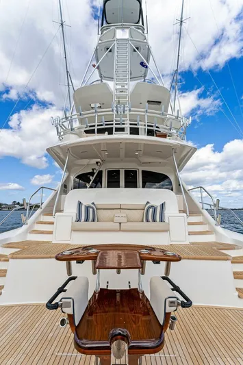 Aussie Rules Yacht Photos Pics 2017 Viking 92 Enclosed Bridge yacht with luxurious deck and seating, under a clear blue sky.