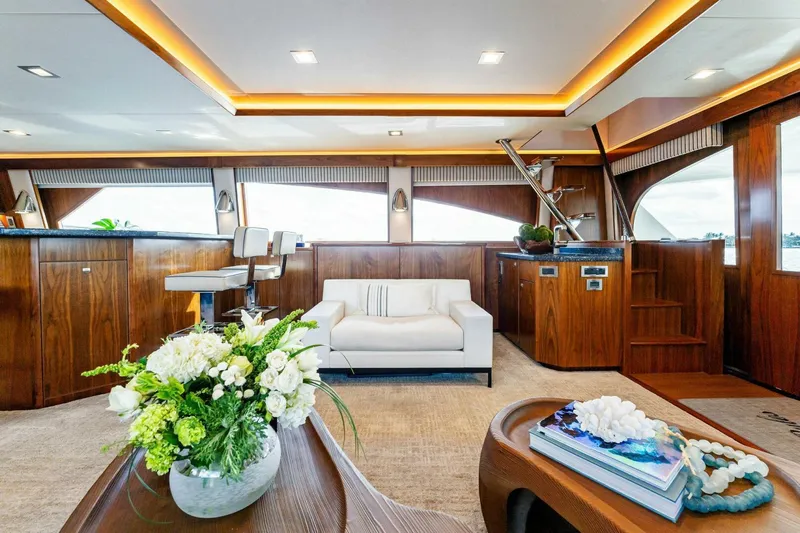 Aussie Rules Yacht Photos Pics Luxurious interior of 2017 Viking 92 Enclosed Bridge yacht with elegant wood finishes.