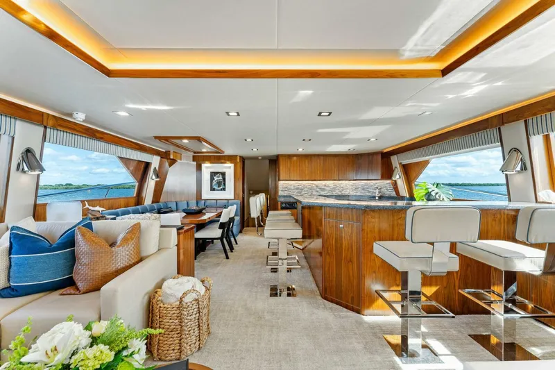 Aussie Rules Yacht Photos Pics Luxurious interior of 2017 Viking 92 Enclosed Bridge yacht with elegant seating and ocean views.