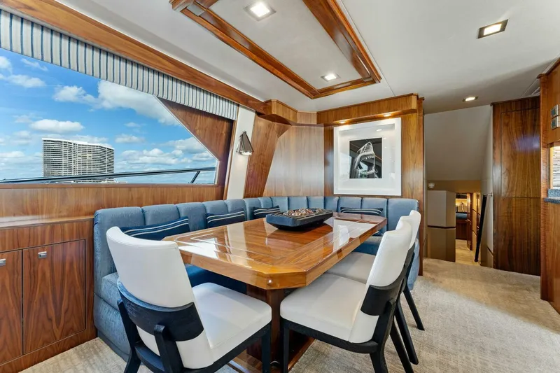 Aussie Rules Yacht Photos Pics Luxurious dining area inside 2017 Viking 92 Enclosed Bridge yacht.
