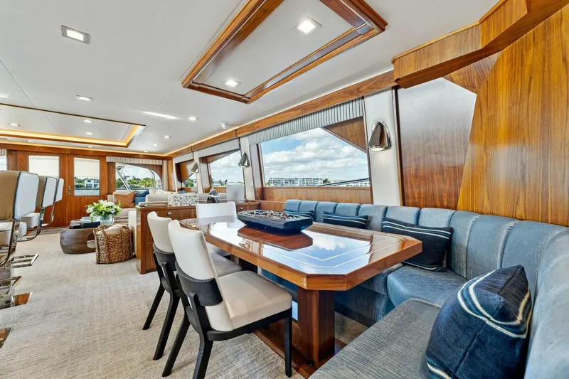 Aussie Rules Yacht Photos Pics Luxurious interior of 2017 Viking 92 Enclosed Bridge yacht with elegant seating and dining area.