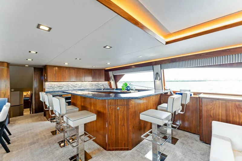 Aussie Rules Yacht Photos Pics Luxurious interior of 2017 Viking 92 Enclosed Bridge yacht with elegant bar seating.