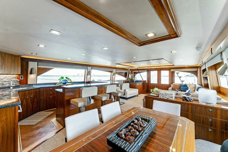 Aussie Rules Yacht Photos Pics Luxurious interior of 2017 Viking 92 Enclosed Bridge yacht with elegant wood finishes.