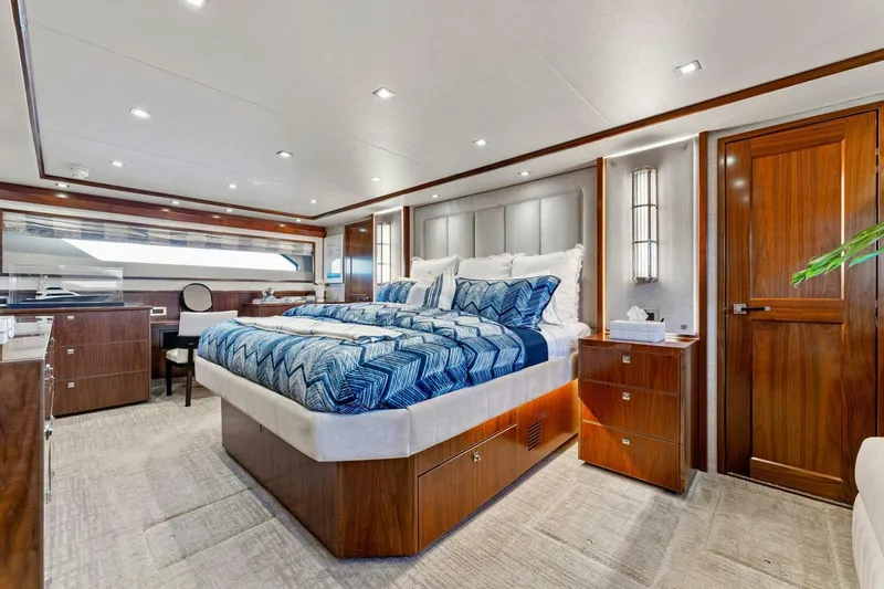 Aussie Rules Yacht Photos Pics Luxurious bedroom interior of 2017 Viking 92 Enclosed Bridge yacht with elegant wood finishes.