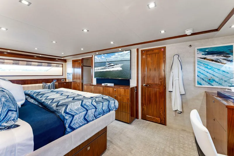 Aussie Rules Yacht Photos Pics Luxurious bedroom interior of 2017 Viking 92 Enclosed Bridge yacht with modern decor.