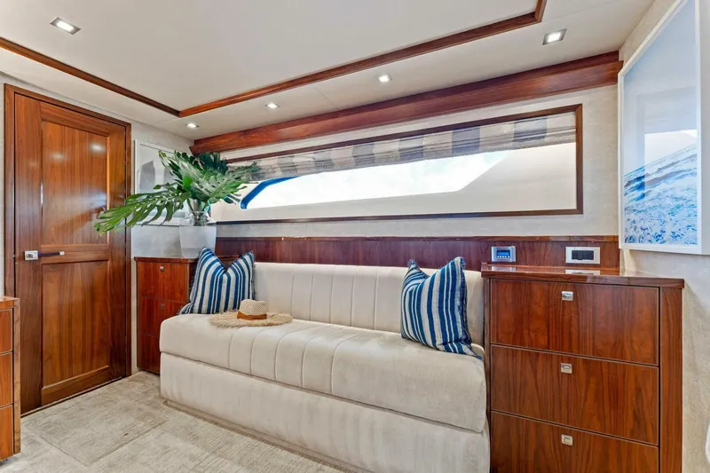 Aussie Rules Yacht Photos Pics Luxurious interior of 2017 Viking 92 Enclosed Bridge yacht with elegant wood finishes.