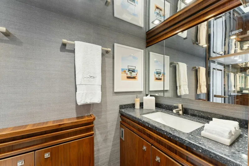 Aussie Rules Yacht Photos Pics Luxurious bathroom in 2017 Viking 92 Enclosed Bridge yacht with elegant wood cabinetry.