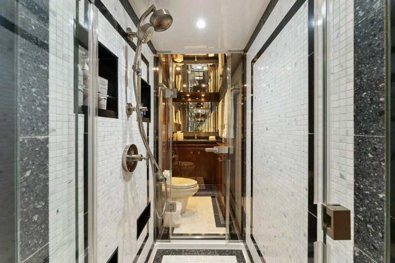 Aussie Rules Yacht Photos Pics Luxurious bathroom in 2017 Viking 92 Enclosed Bridge yacht, featuring elegant tile design and modern fixtures.