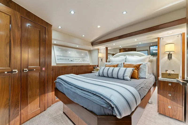 Aussie Rules Yacht Photos Pics Luxurious bedroom interior of 2017 Viking 92 Enclosed Bridge yacht with elegant wood finishes.