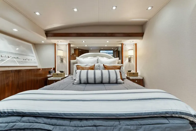 Aussie Rules Yacht Photos Pics Luxurious bedroom interior of 2017 Viking 92 Enclosed Bridge yacht with elegant bedding.
