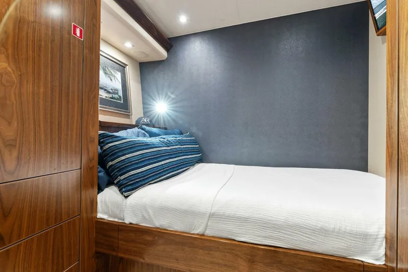 Aussie Rules Yacht Photos Pics Cozy bedroom in 2017 Viking 92 Enclosed Bridge yacht with wood accents and modern lighting.
