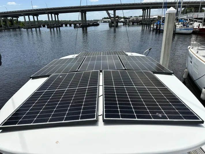 Blue Yacht Photos Pics Solar panels on a 2006 Hanse 461 yacht docked near a bridge.