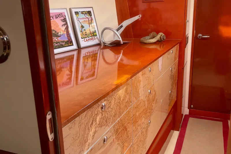 Blue Yacht Photos Pics Interior of 2006 Hanse 461 yacht with wooden cabinetry and decorative artwork.