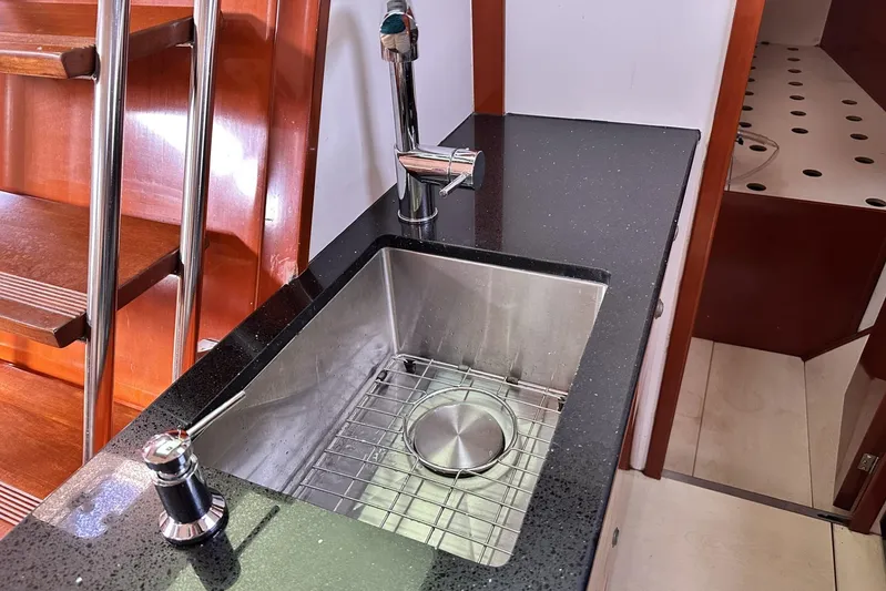 Blue Yacht Photos Pics Modern kitchen sink on 2006 Hanse 461 yacht with sleek black countertop.