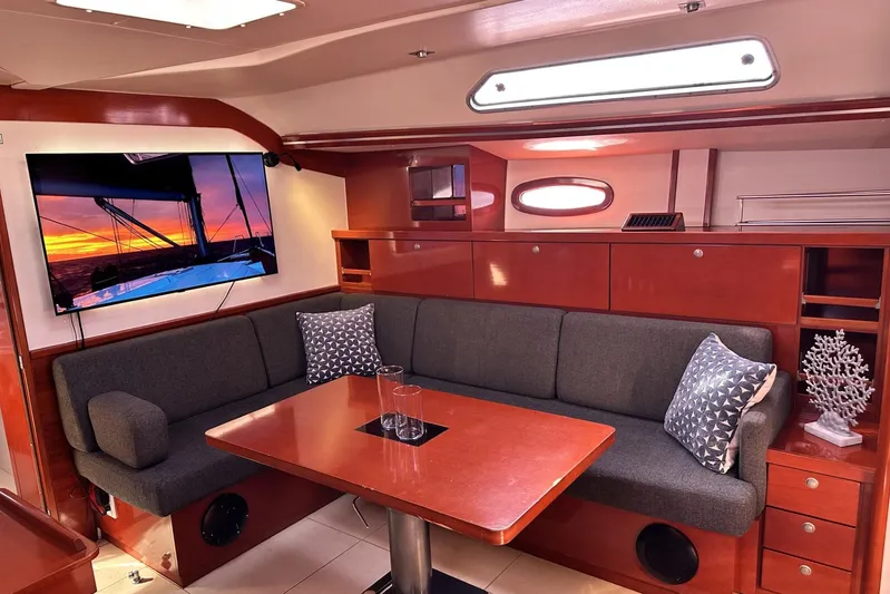 Blue Yacht Photos Pics Luxurious 2006 Hanse 461 yacht interior with cozy seating, TV, and elegant wooden finishes.