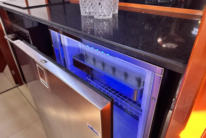 Blue Yacht Photos Pics Open stainless steel fridge in 2006 Hanse 461 yacht kitchen with blue interior lighting.