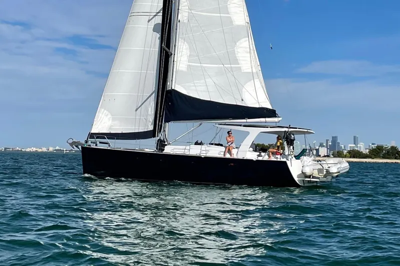 Blue Yacht Photos Pics Sailing yacht Hanse 461, 2006 model, cruising on blue waters near a city skyline.