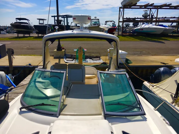  Yacht Photos Pics 2010 Sea Ray 330 Sundancer docked at marina, showcasing open cockpit and windshield.