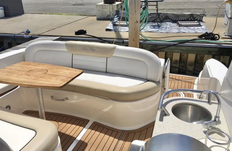  Yacht Photos Pics Luxury seating area on 2010 Sea Ray 330 Sundancer yacht with wooden table and sink.
