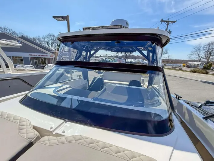  Yacht Photos Pics 2025 Navan S30 boat with sleek windshield and modern design, parked outdoors.