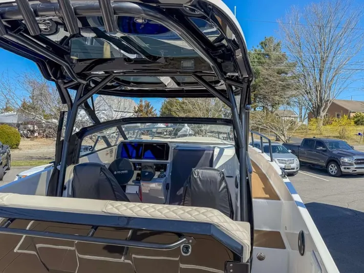  Yacht Photos Pics 2025 Navan S30 boat interior with modern dashboard and seating, parked outdoors.