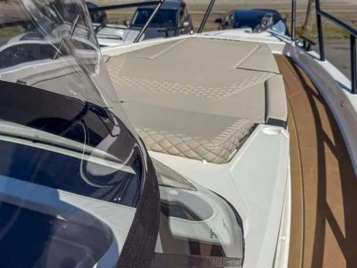  Yacht Photos Pics 2025 Navan S30 boat with sleek design and cushioned deck, docked outdoors.