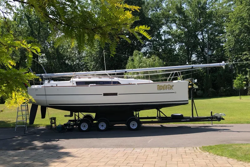  Yacht Photos Pics 2015 Dufour 310 Grand Large sailboat on trailer in a green setting.