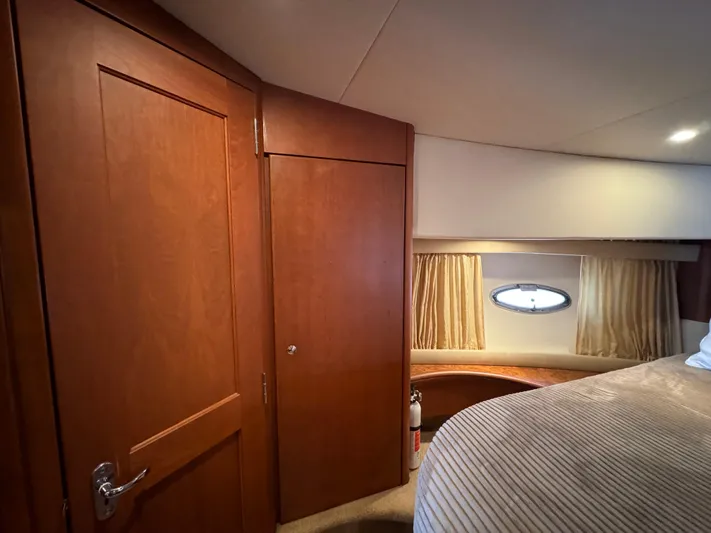 Seas The Reins Yacht Photos Pics 2006 Silverton 43 Sport Bridge cabin interior with wood paneling and porthole window.