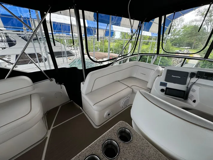Seas The Reins Yacht Photos Pics Interior view of 2006 Silverton 43 Sport Bridge yacht with seating and navigation equipment.