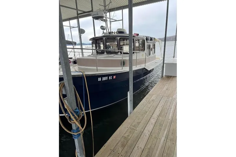 Lady Mary Yacht Photos Pics 2009 Ranger Tugs R-29 docked under a covered marina on a calm lake.