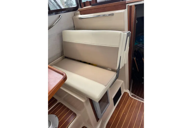 Lady Mary Yacht Photos Pics 2009 Ranger Tugs R-29 interior seating with beige upholstery and wooden accents.