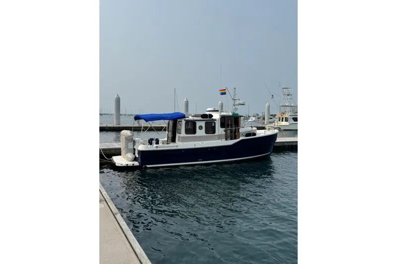 Lady Mary Yacht Photos Pics 2009 Ranger Tugs R-29 boat docked at marina with blue canopy.