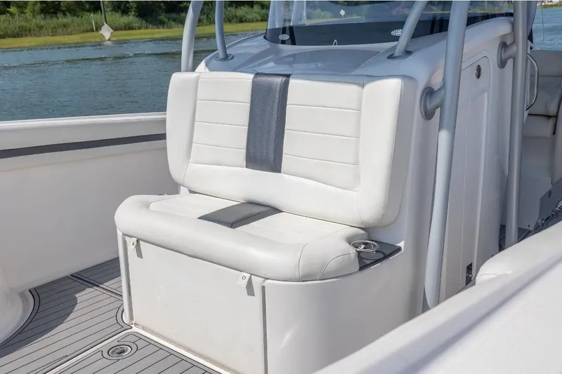  Yacht Photos Pics 2014 Nor-Tech 390 Sport Cuddy Center Console with white seating, on a calm waterway.