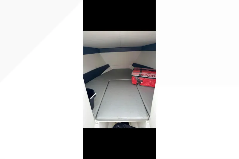  Yacht Photos Pics 2014 Nor-Tech 390 Sport Cuddy interior with life jackets and seating area.