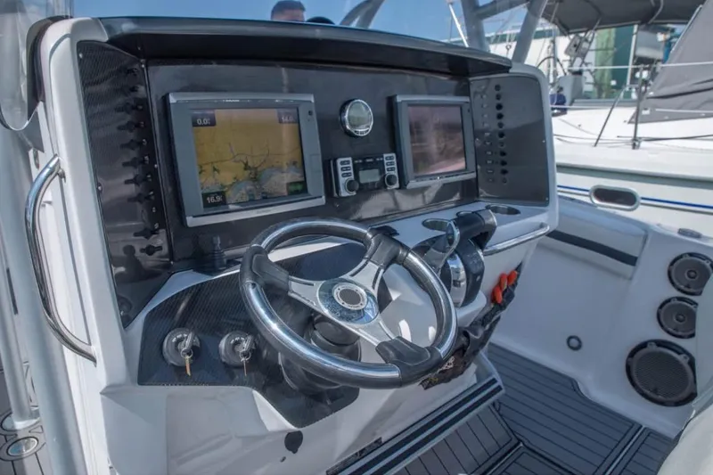  Yacht Photos Pics 2014 Nor-Tech 390 Sport Cuddy Center Console dashboard with navigation screens and steering wheel.