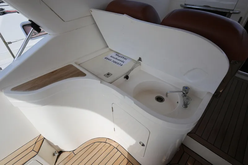  Yacht Photos Pics 1993 Princess 366 Riviera yacht sink area with wooden accents and faucet.