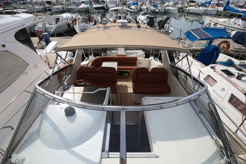  Yacht Photos Pics 1993 Princess 366 Riviera yacht with spacious deck and seating, docked in a marina.