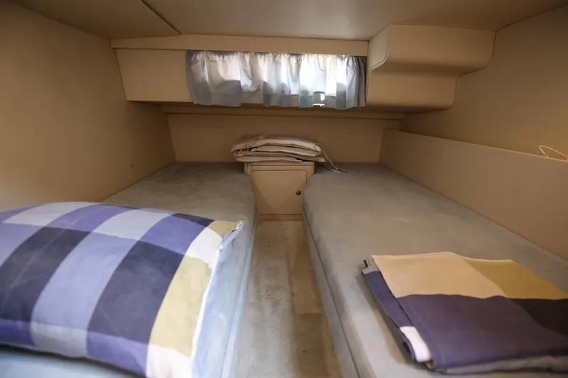  Yacht Photos Pics Cozy twin cabin interior of 1993 Princess 366 Riviera yacht with soft lighting.
