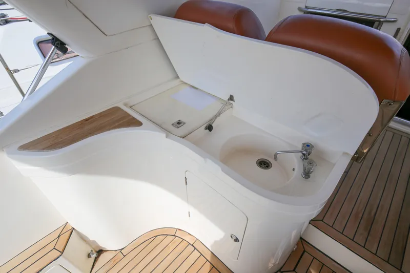  Yacht Photos Pics 1993 Princess 366 Riviera yacht sink area with wooden accents and seating.