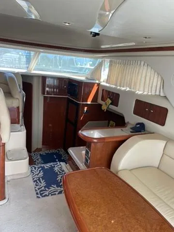  Yacht Photos Pics Interior of 2003 Sea Ray 400 Sedan Bridge yacht with elegant seating and wooden finishes.