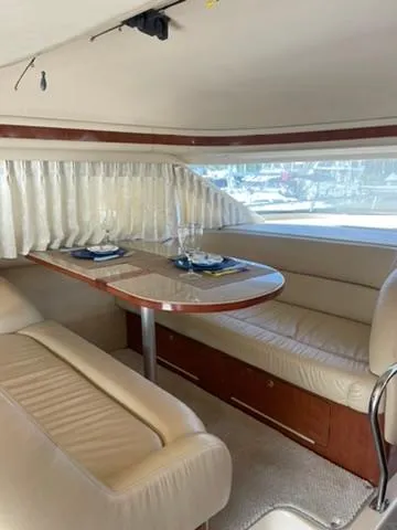  Yacht Photos Pics 2003 Sea Ray 400 Sedan Bridge interior with elegant dining area and leather seating.